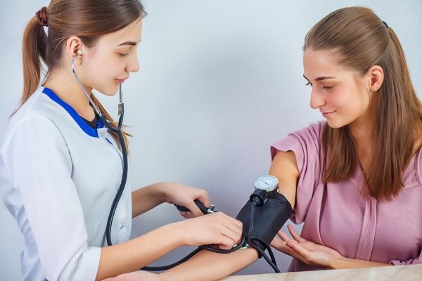 Close Up Of A Doctor Checking Blood Pressure Of A Patient. Healthcare, healthy lifestyle and medical service concept.