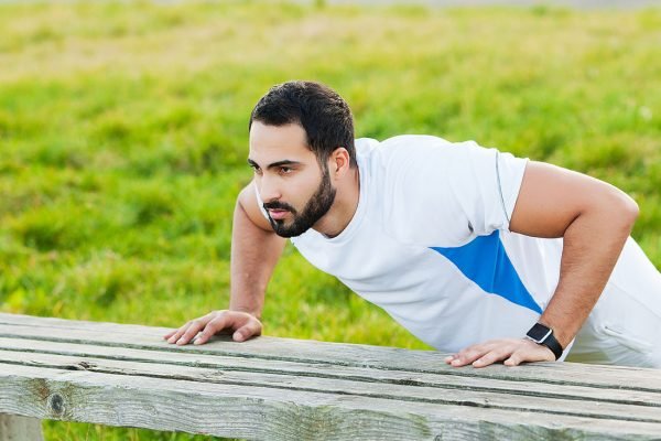 Young and sporty man training outdoor in sportswear. Sport, health, athletics.